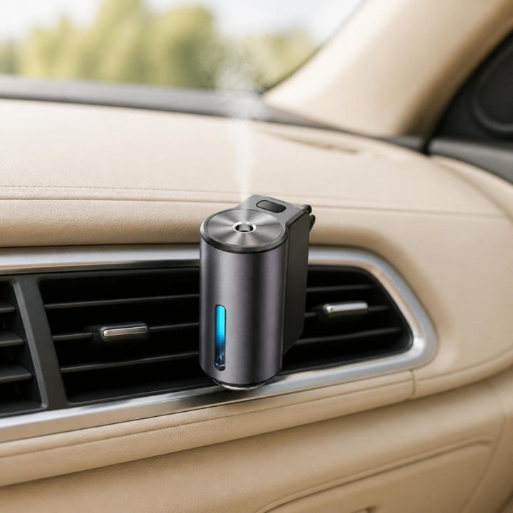 Car vent mist diffuser clipped to the air vent in a beige car interior