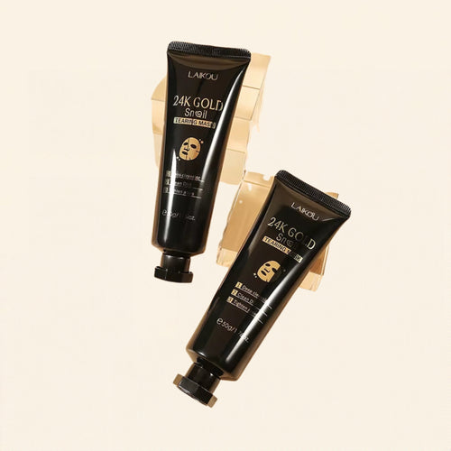 Two 24K gold peel-off face mask tubes on a warm ivory background