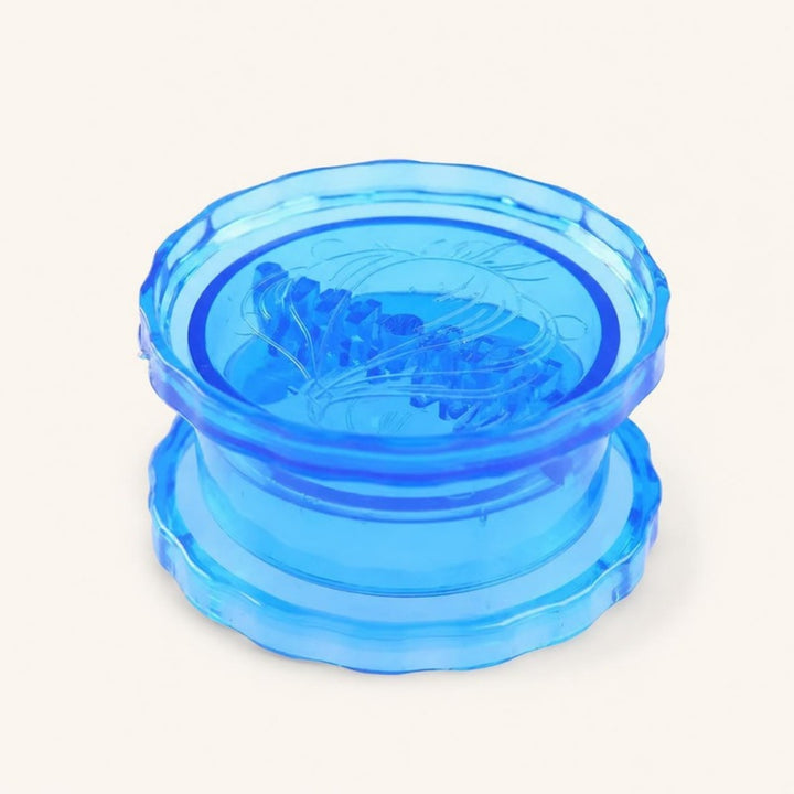 Blue twist garlic crusher on a warm ivory background