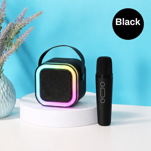 Black portable speaker with colorful gradient and two black microphones on a white surface with a blue background.
