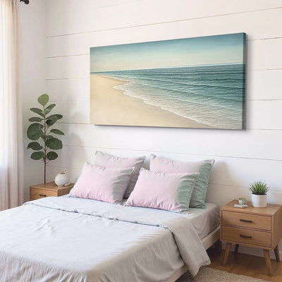 Beach Shoreline II coastal canvas wall art above a bed with pink pillows