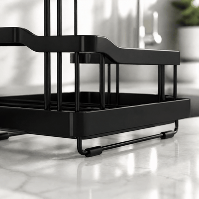 Black slotted sink caddy on a marble countertop