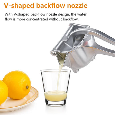 Juice pouring from the V-shaped spout of the lever juicer into a glass