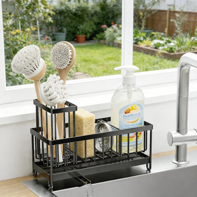 Sink caddy with dish brushes, sponge and soap on a windowsill beside the kitchen sink
