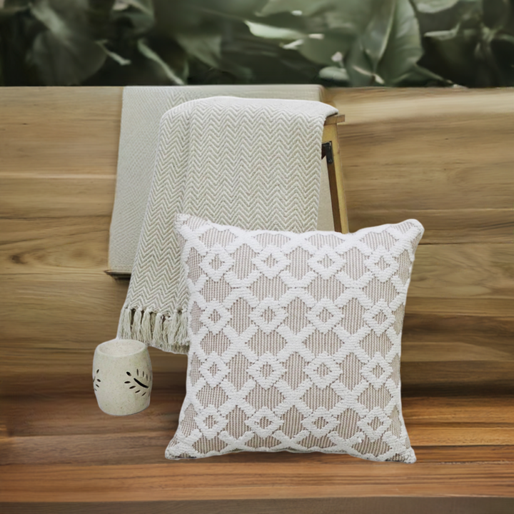 Beige geometric textured throw pillow on a wooden bench with a knit throw and ceramic vase