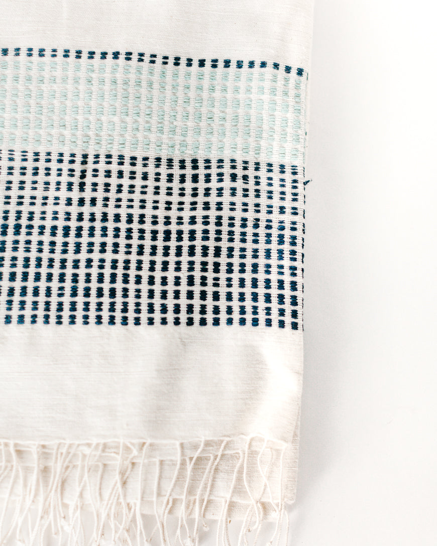 Close-up of the Camden handwoven cotton throw in Azure and Navy with dotted woven bands and fringe