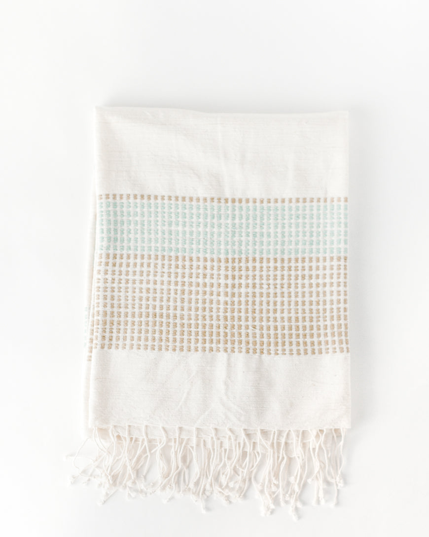Folded Camden handwoven cotton throw in Azure and Sand with knotted fringe